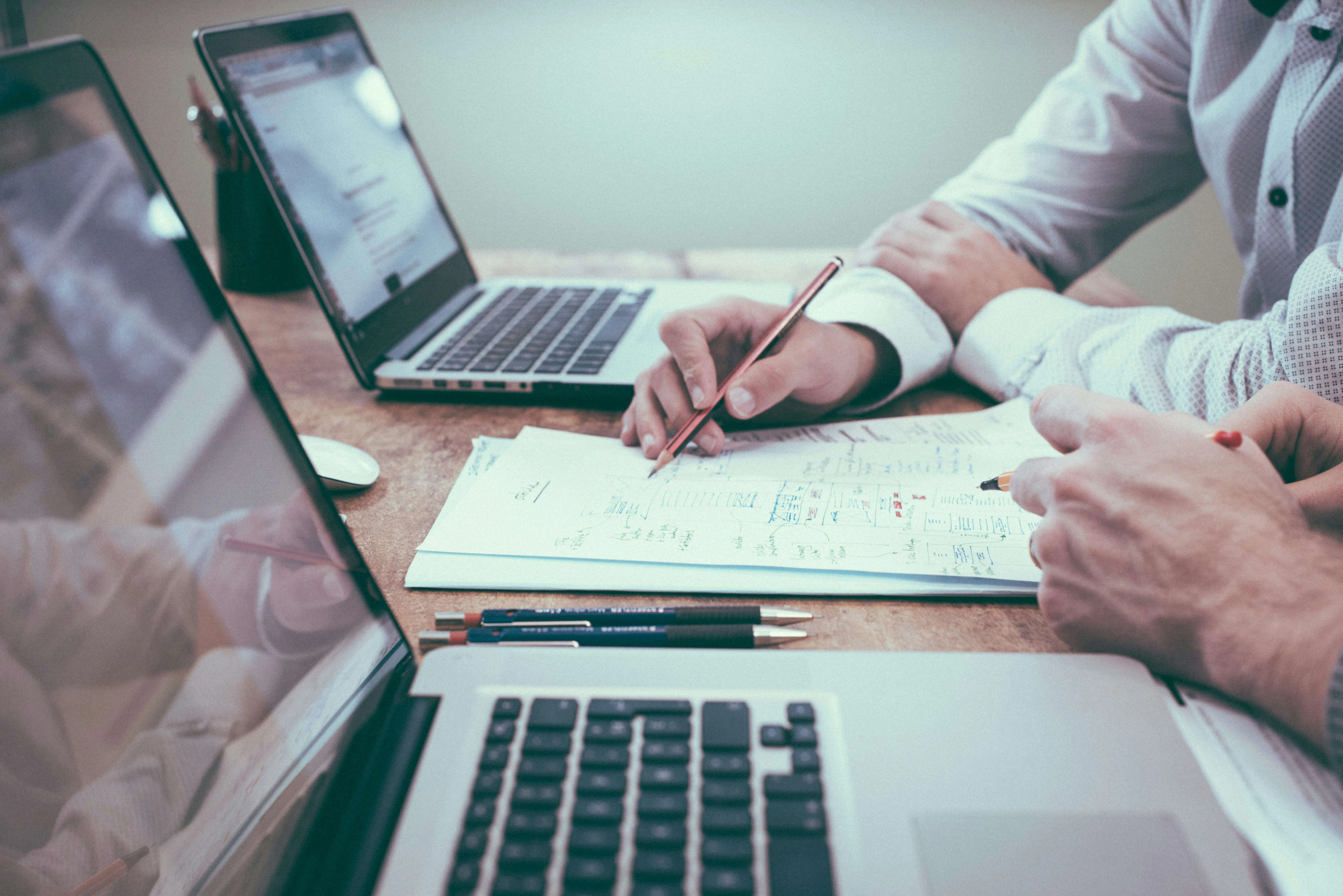 Business consultant working with laptop and notepad for Microsoft 365 and web design services